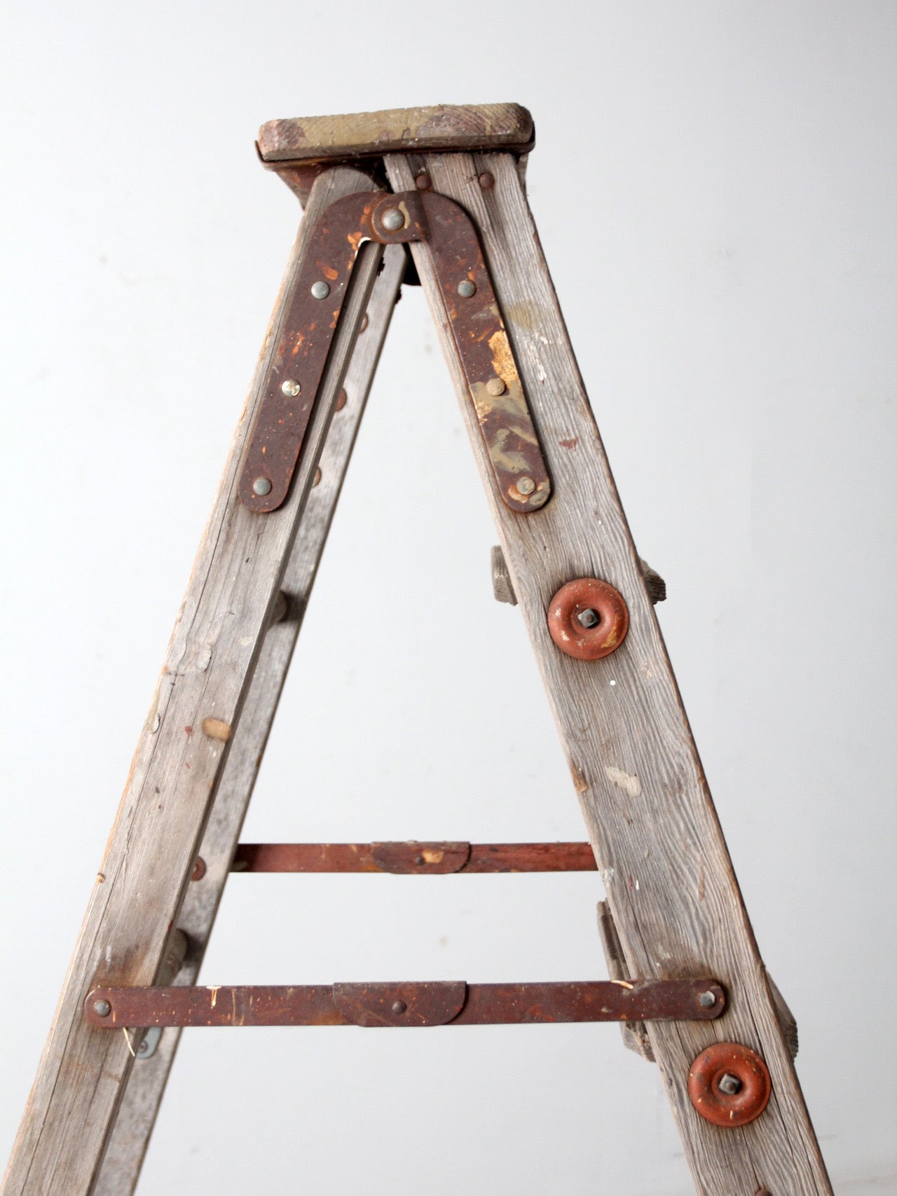 vintage wooden ladder with metal braces