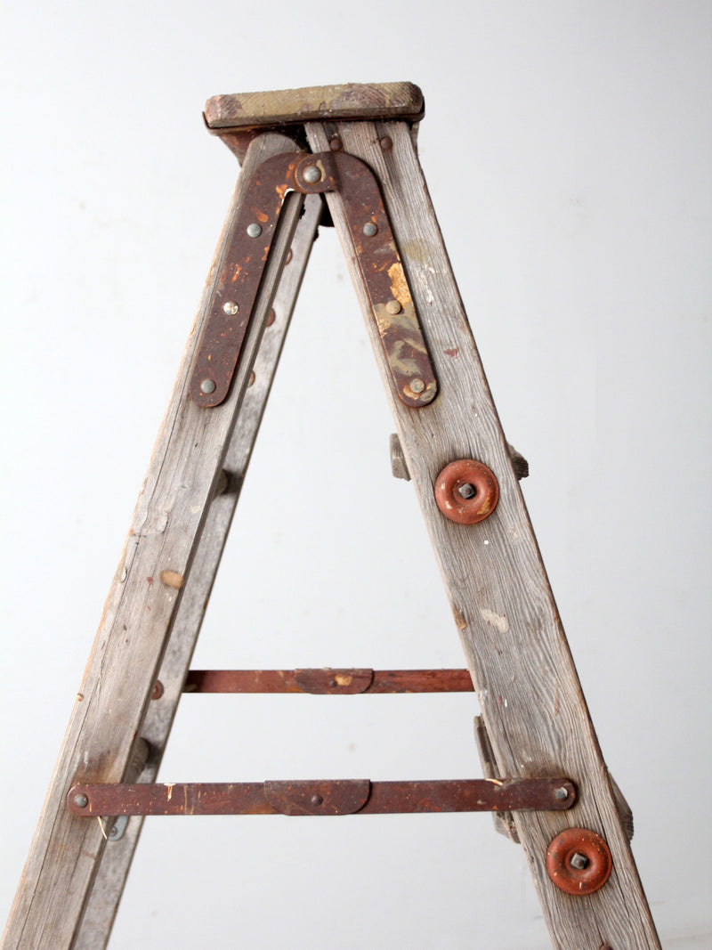 vintage wooden ladder with metal braces