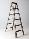 vintage wooden ladder with metal braces