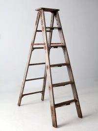 vintage wooden ladder with metal braces