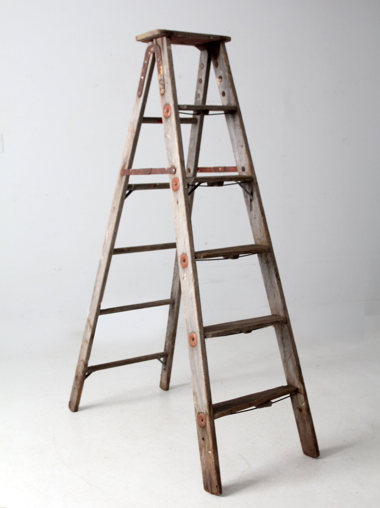 vintage wooden ladder with metal braces