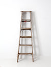 vintage wooden ladder with metal braces