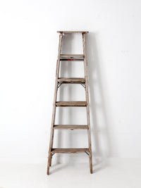 vintage wooden ladder with metal braces
