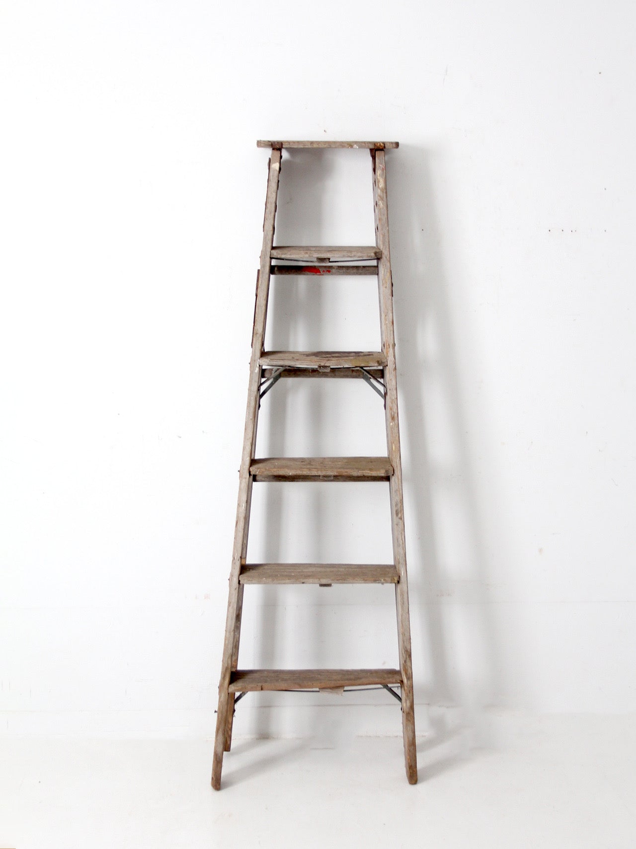 vintage wooden ladder with metal braces