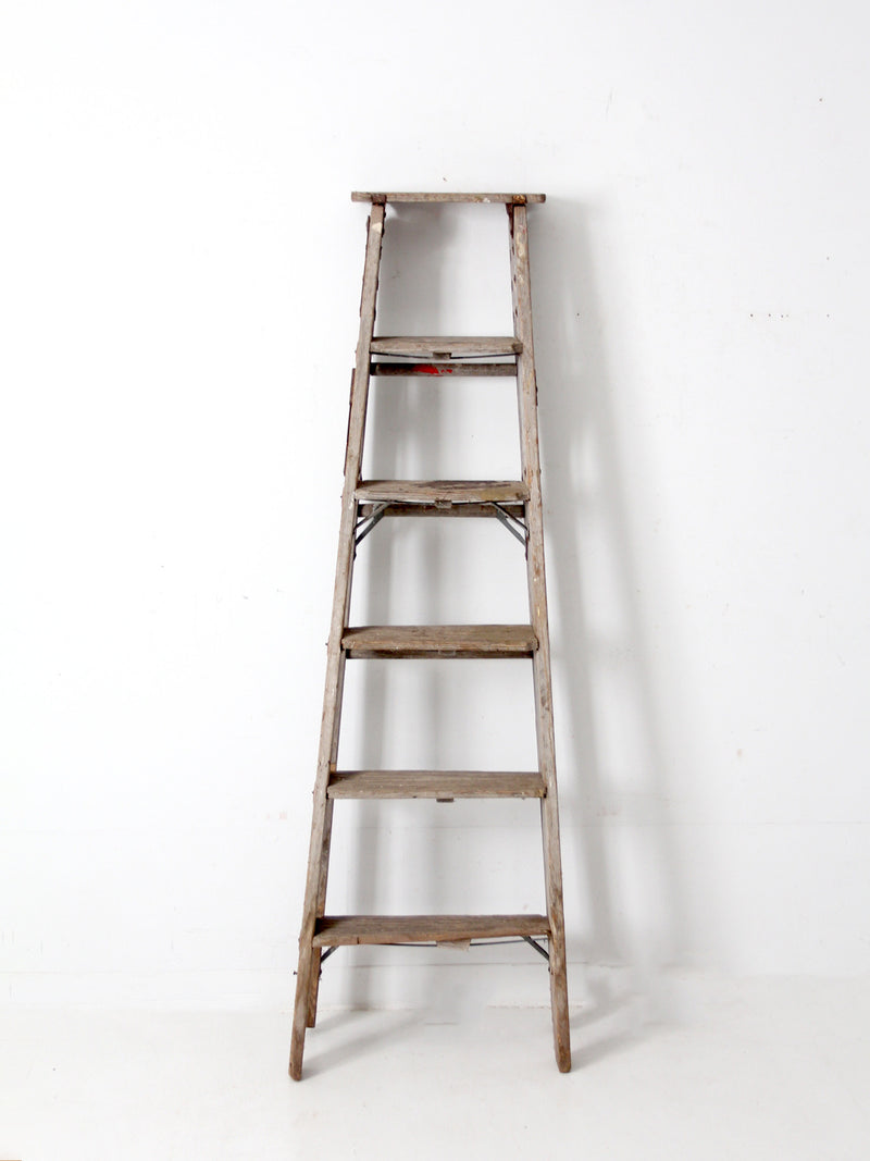 vintage wooden ladder with metal braces