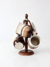 set of vintage handmade studio pottery mugs with wooden stand