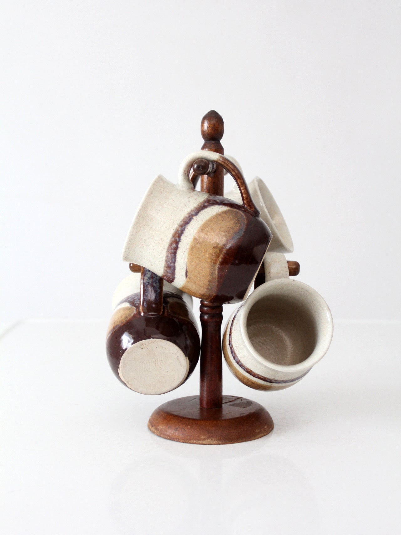 set of vintage handmade studio pottery mugs with wooden stand