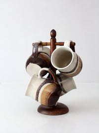 set of vintage handmade studio pottery mugs with wooden stand