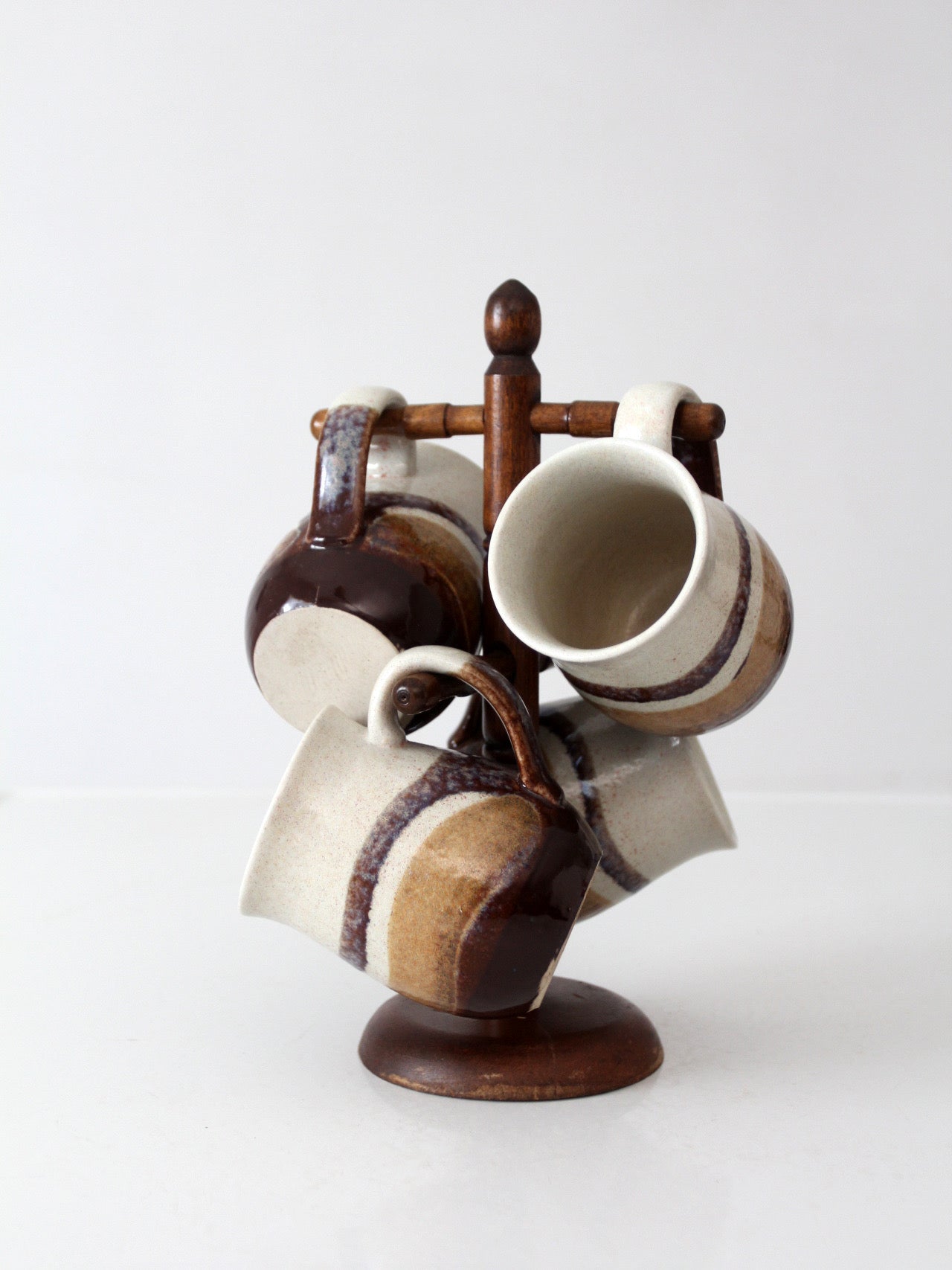 set of vintage handmade studio pottery mugs with wooden stand