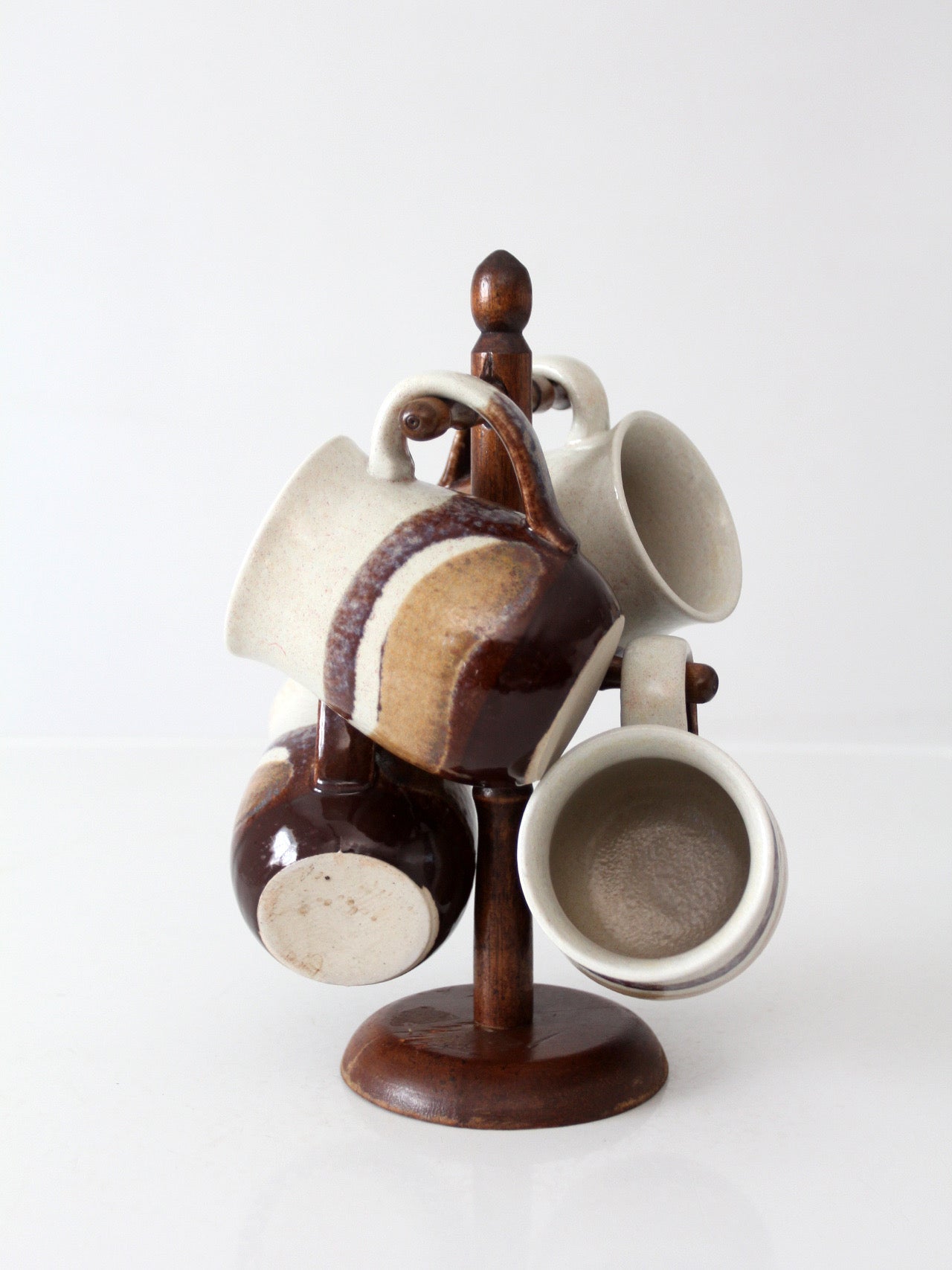 set of vintage handmade studio pottery mugs with wooden stand
