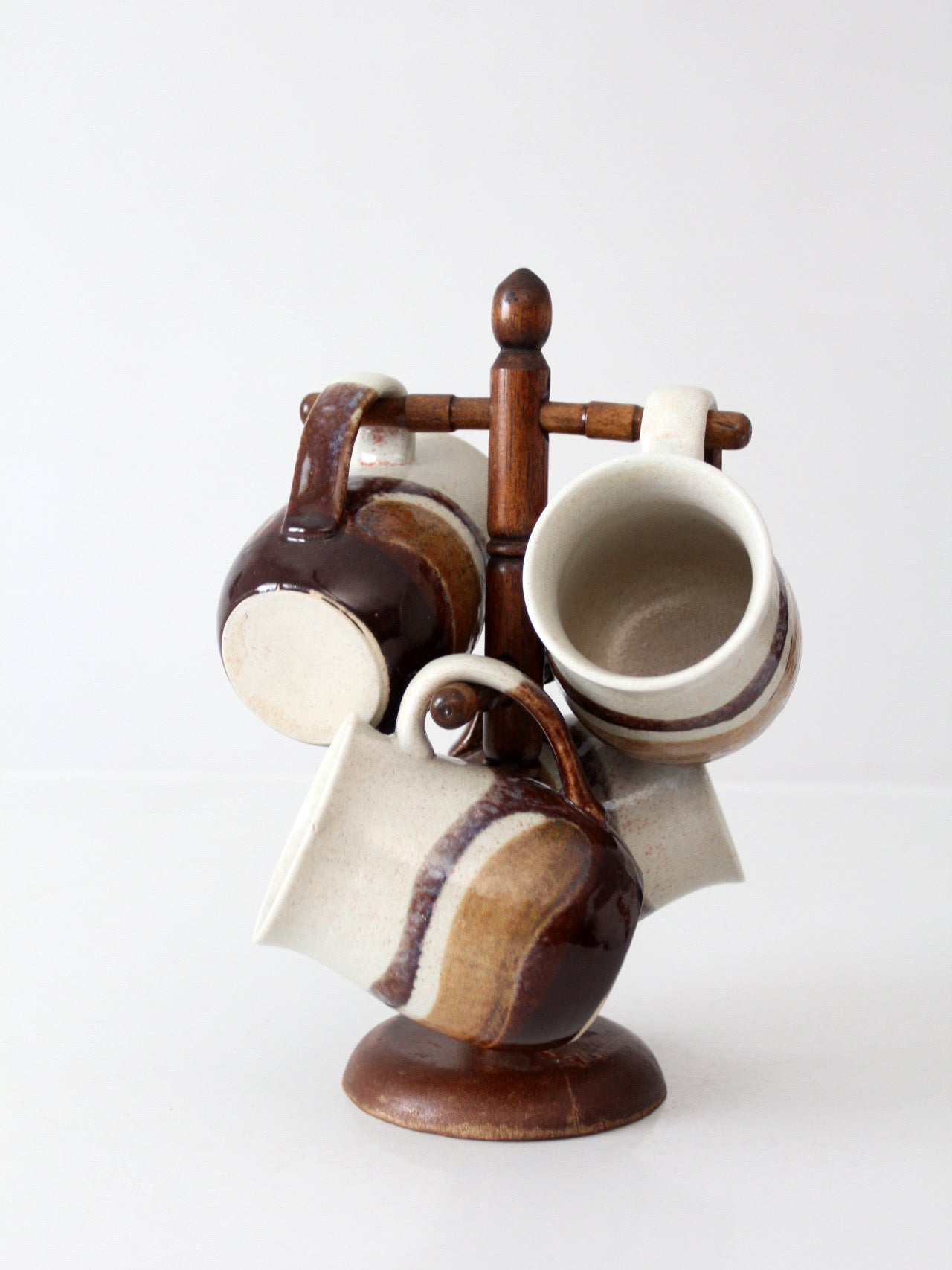 set of vintage handmade studio pottery mugs with wooden stand