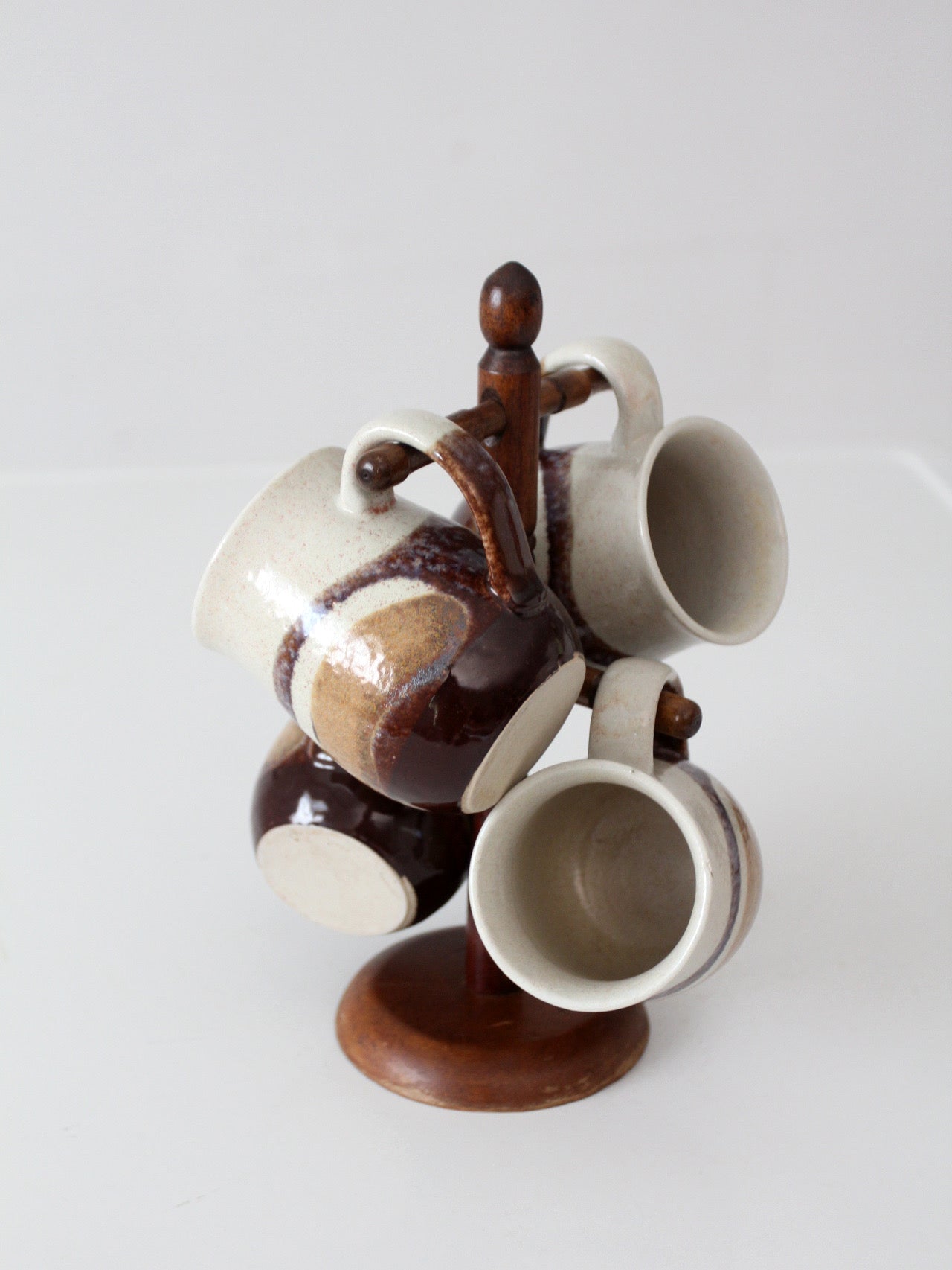set of vintage handmade studio pottery mugs with wooden stand