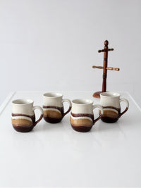 set of vintage handmade studio pottery mugs with wooden stand