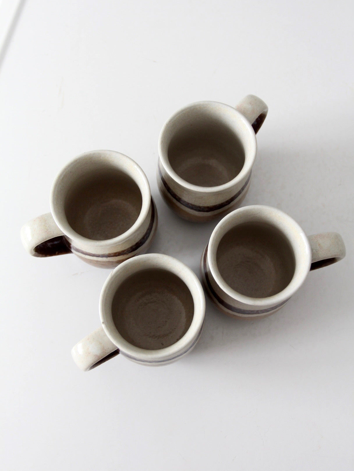 set of vintage handmade studio pottery mugs with wooden stand