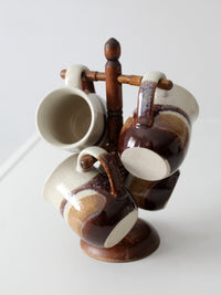 set of vintage handmade studio pottery mugs with wooden stand