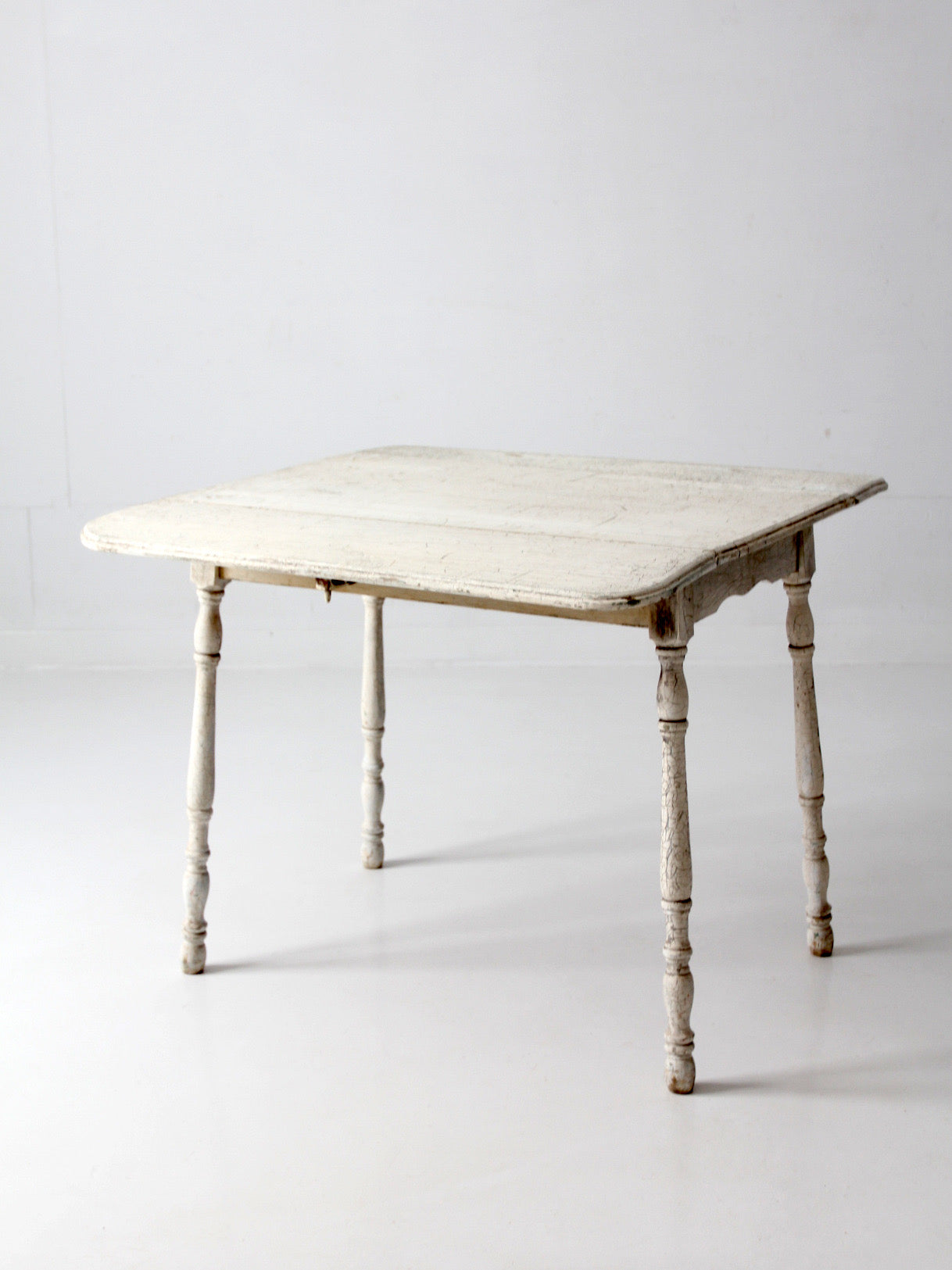 antique white painted drop leaf farmhouse table