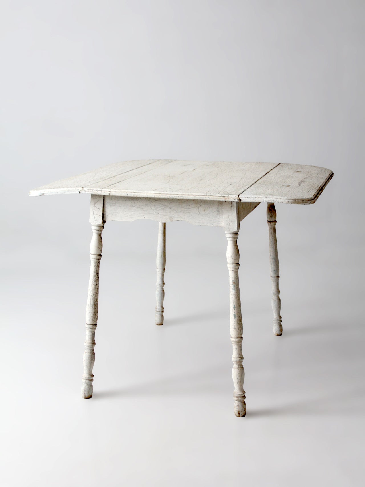 antique white painted drop leaf farmhouse table