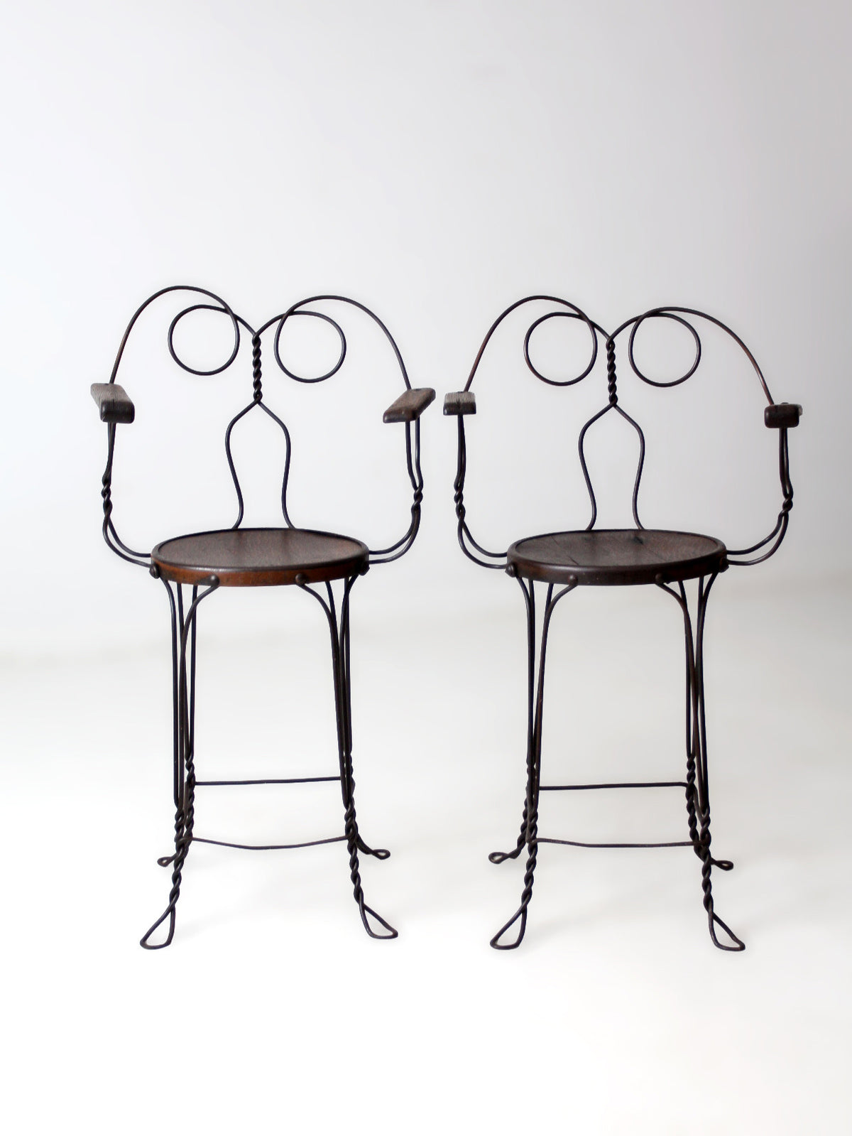 pair of antique A.H. Andrews & Co. wire bar stools