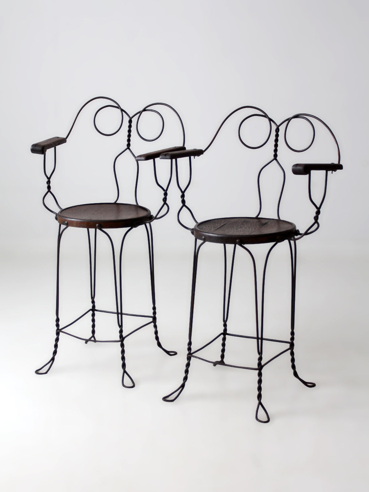 pair of antique A.H. Andrews & Co. wire bar stools