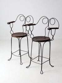 pair of antique A.H. Andrews & Co. wire bar stools