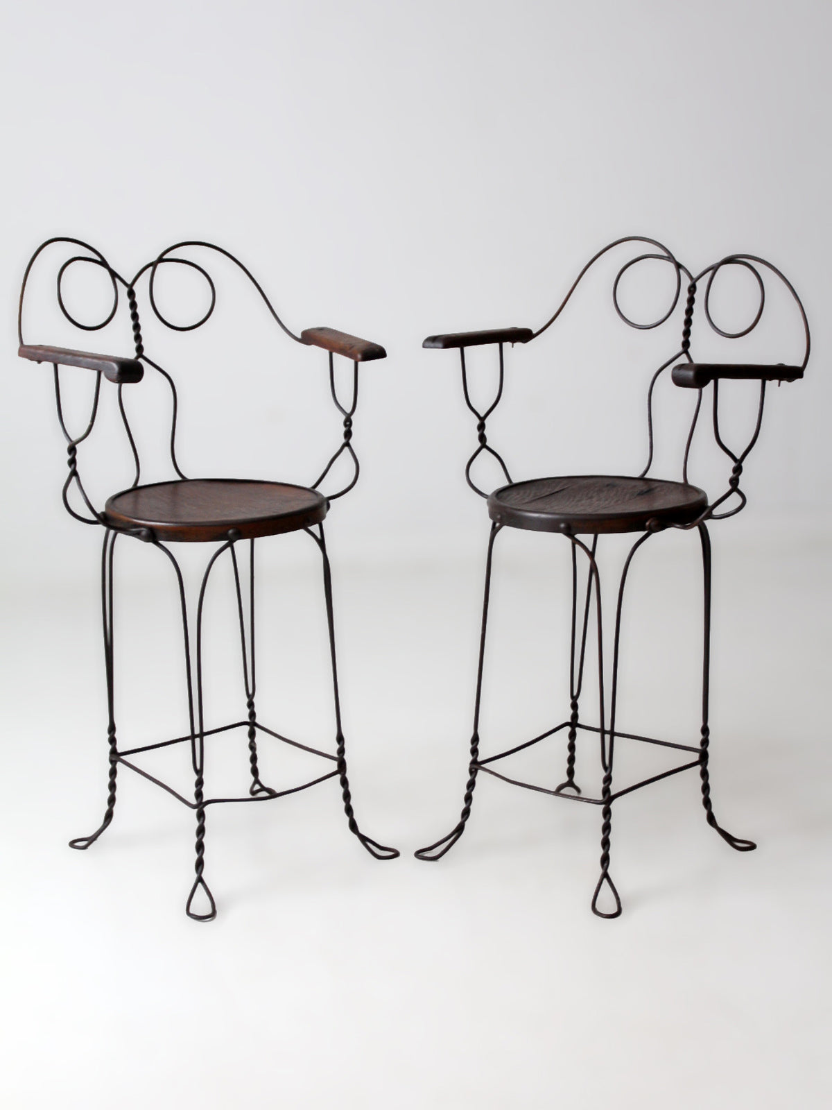 pair of antique A.H. Andrews & Co. wire bar stools