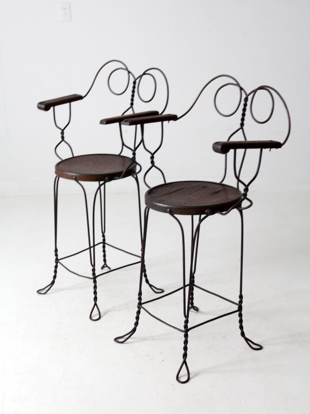 pair of antique A.H. Andrews & Co. wire bar stools