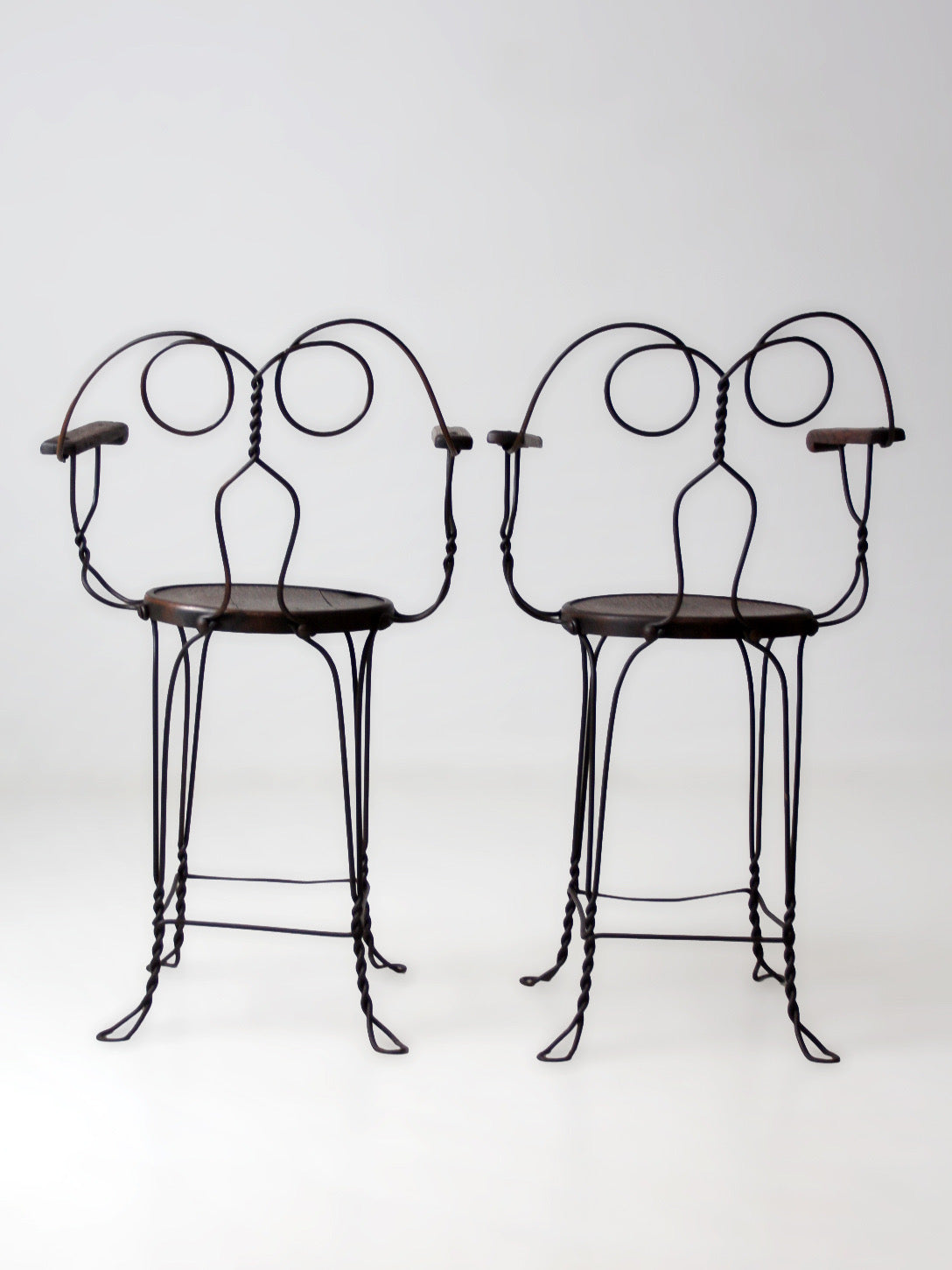 pair of antique A.H. Andrews & Co. wire bar stools