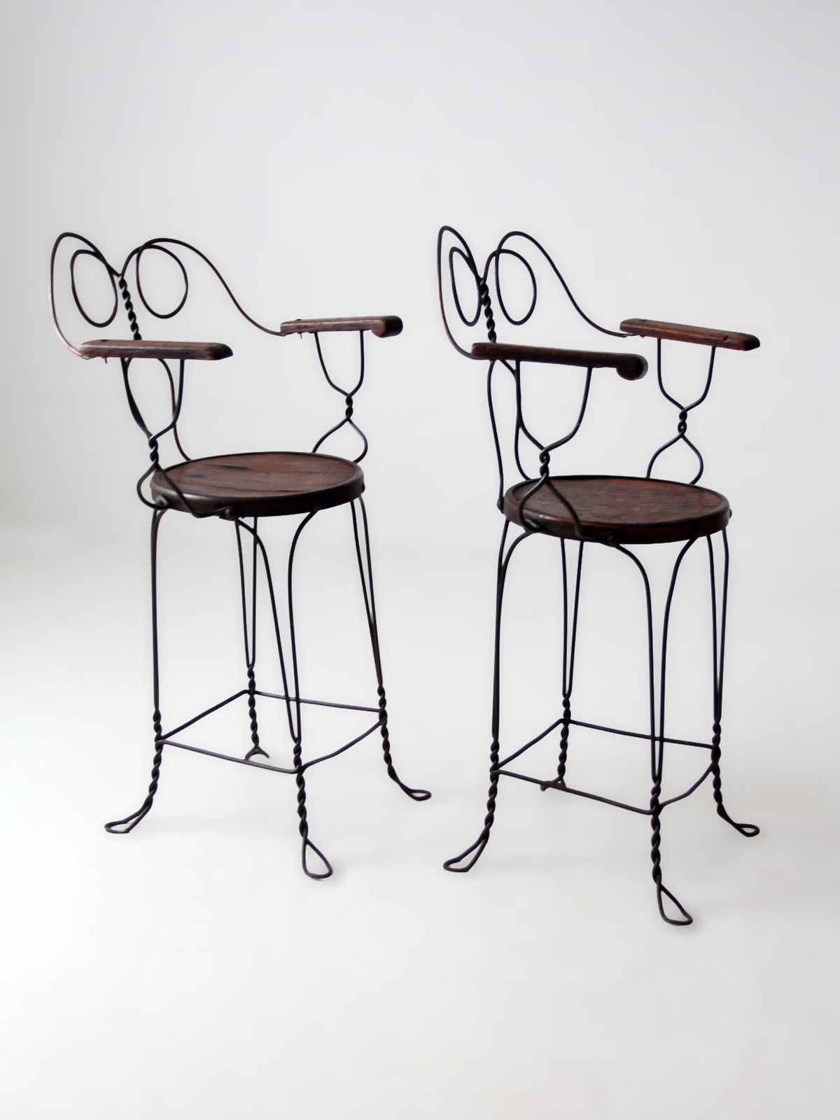pair of antique A.H. Andrews & Co. wire bar stools