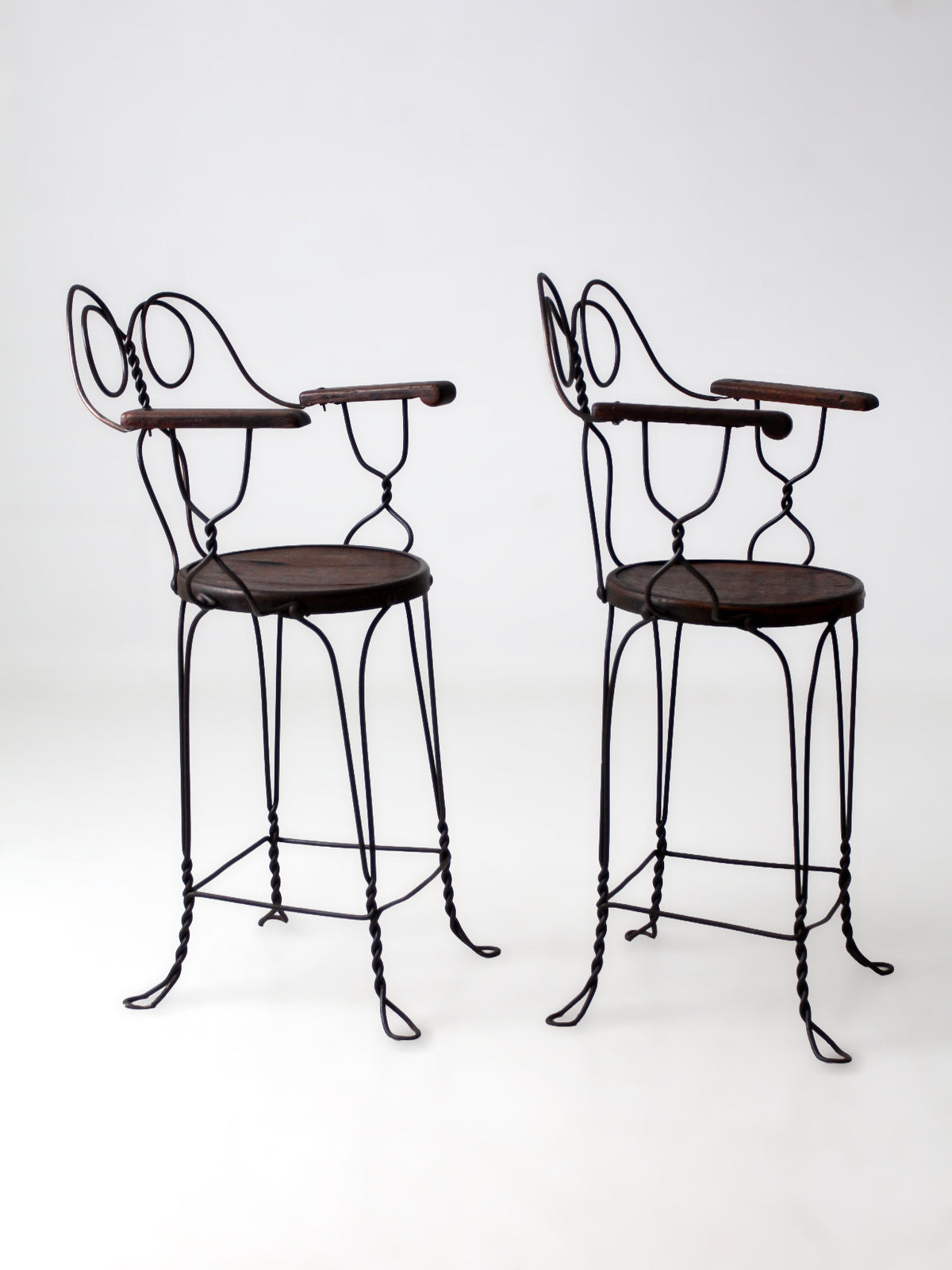 pair of antique A.H. Andrews & Co. wire bar stools