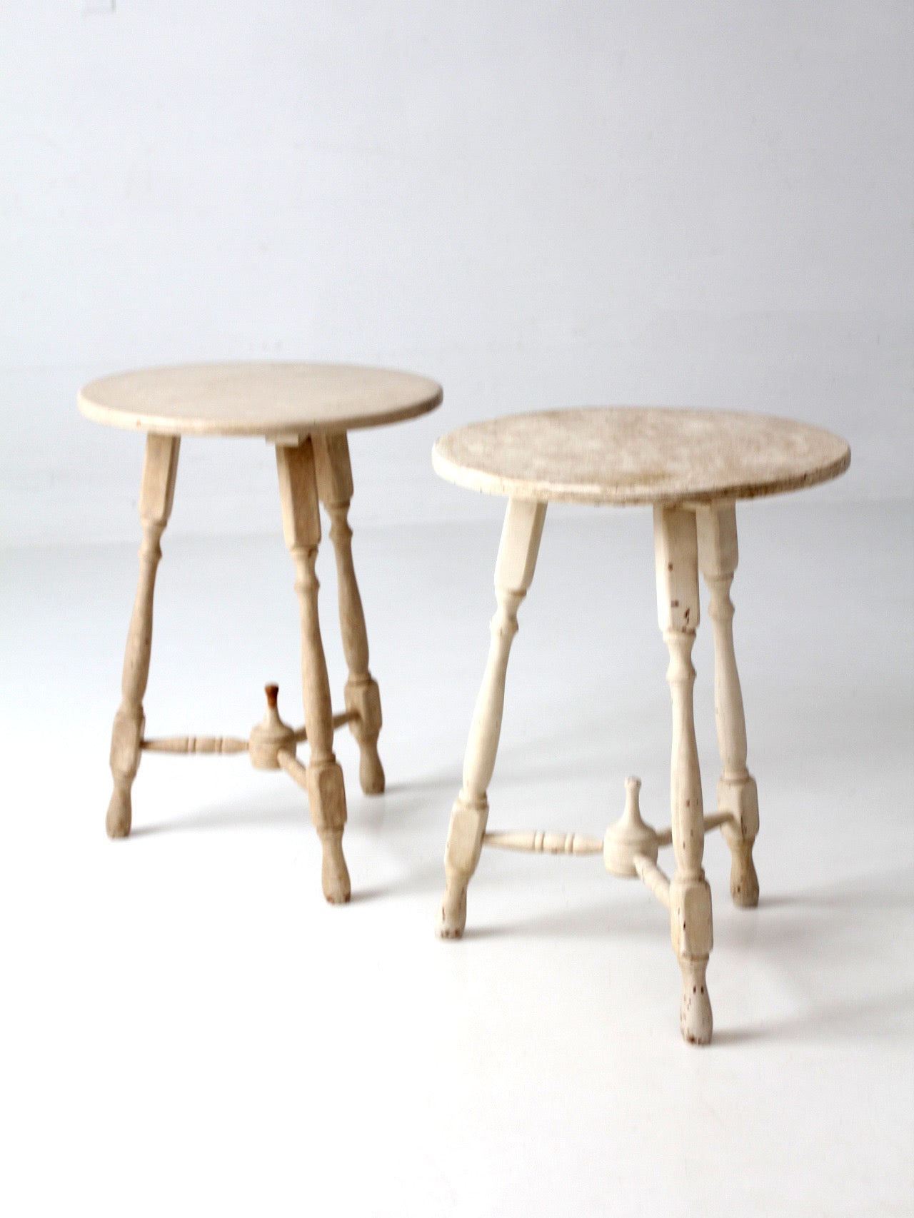 pair of vintage cottage pedestal tables