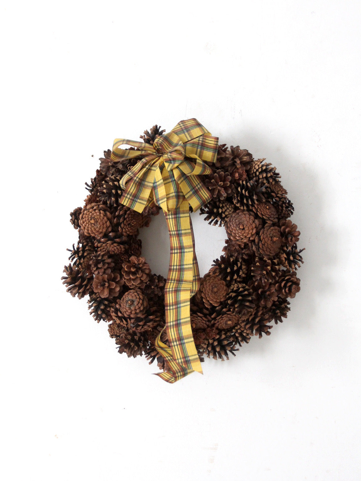 vintage pine cone wreath with tartan ribbon