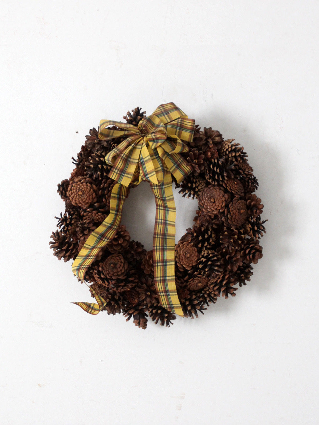 vintage pine cone wreath with tartan ribbon