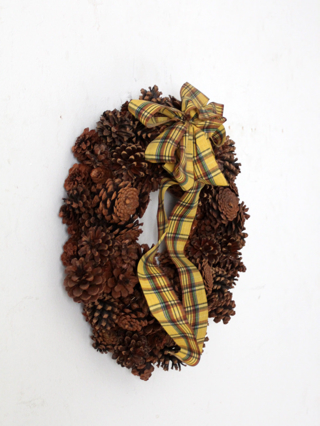 vintage pine cone wreath with tartan ribbon