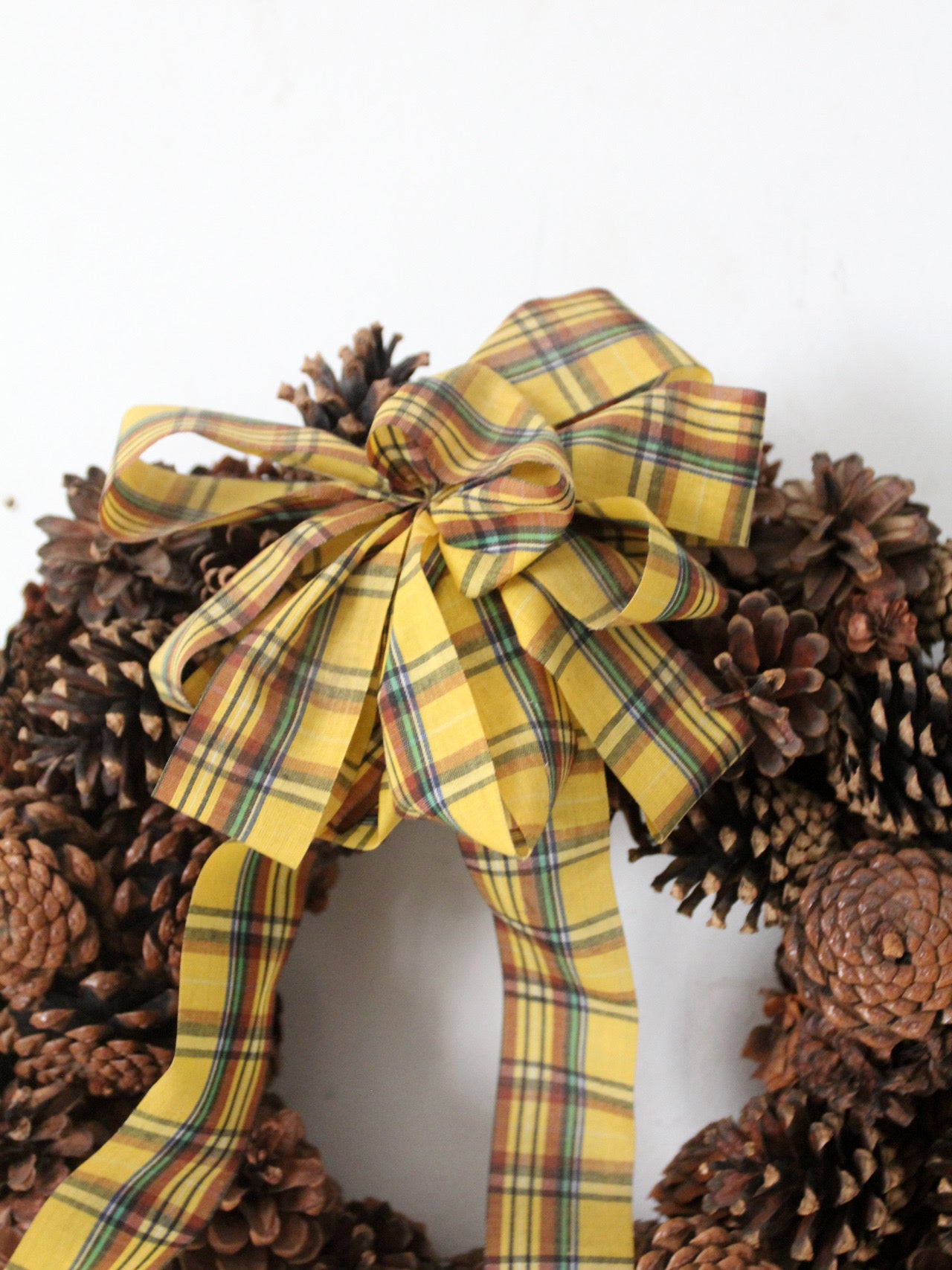 vintage pine cone wreath with tartan ribbon
