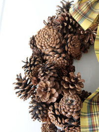 vintage pine cone wreath with tartan ribbon