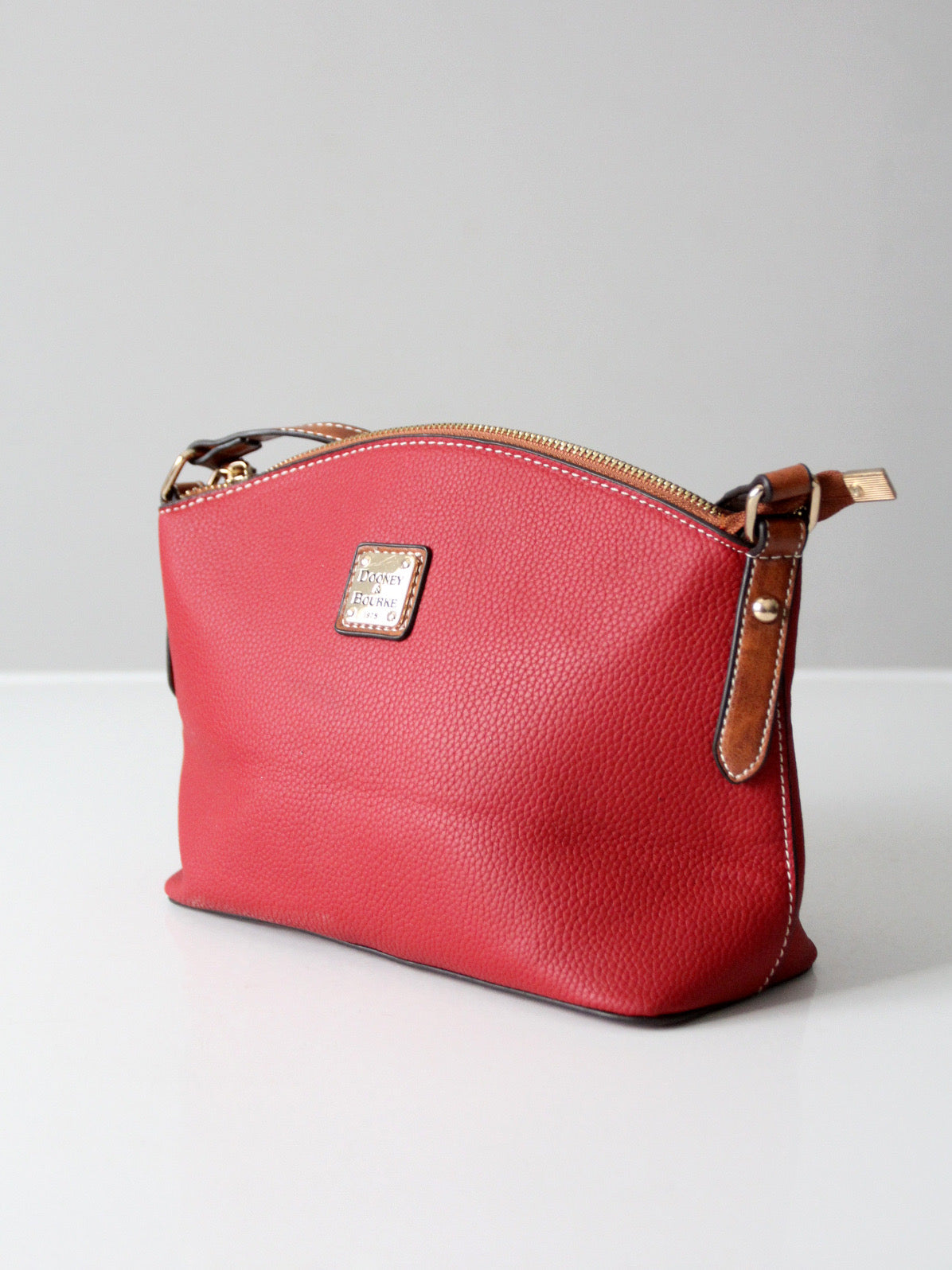 Dooney & Bourke red pebble leather domed crossbody bag
