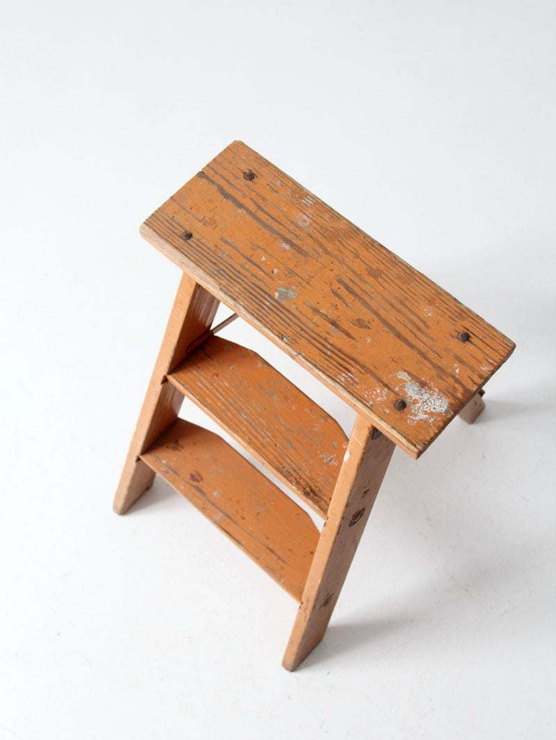 vintage orange wooden step ladder