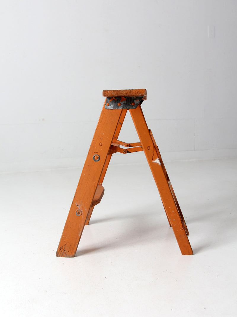 vintage orange wooden step ladder