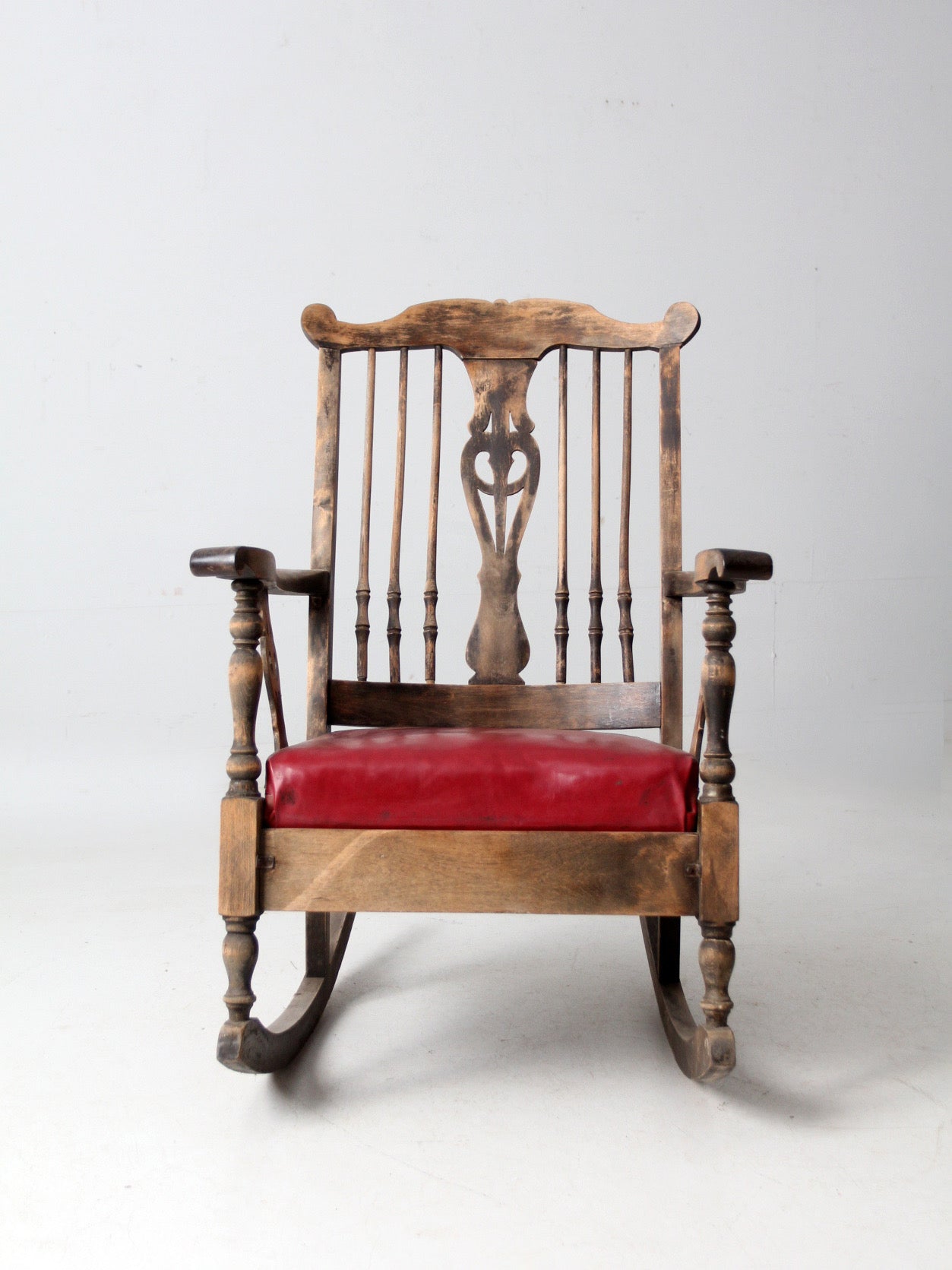 antique wooden rocking chair with upholstered seat