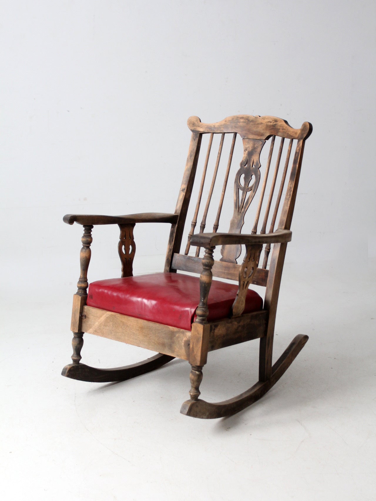 antique wooden rocking chair with upholstered seat