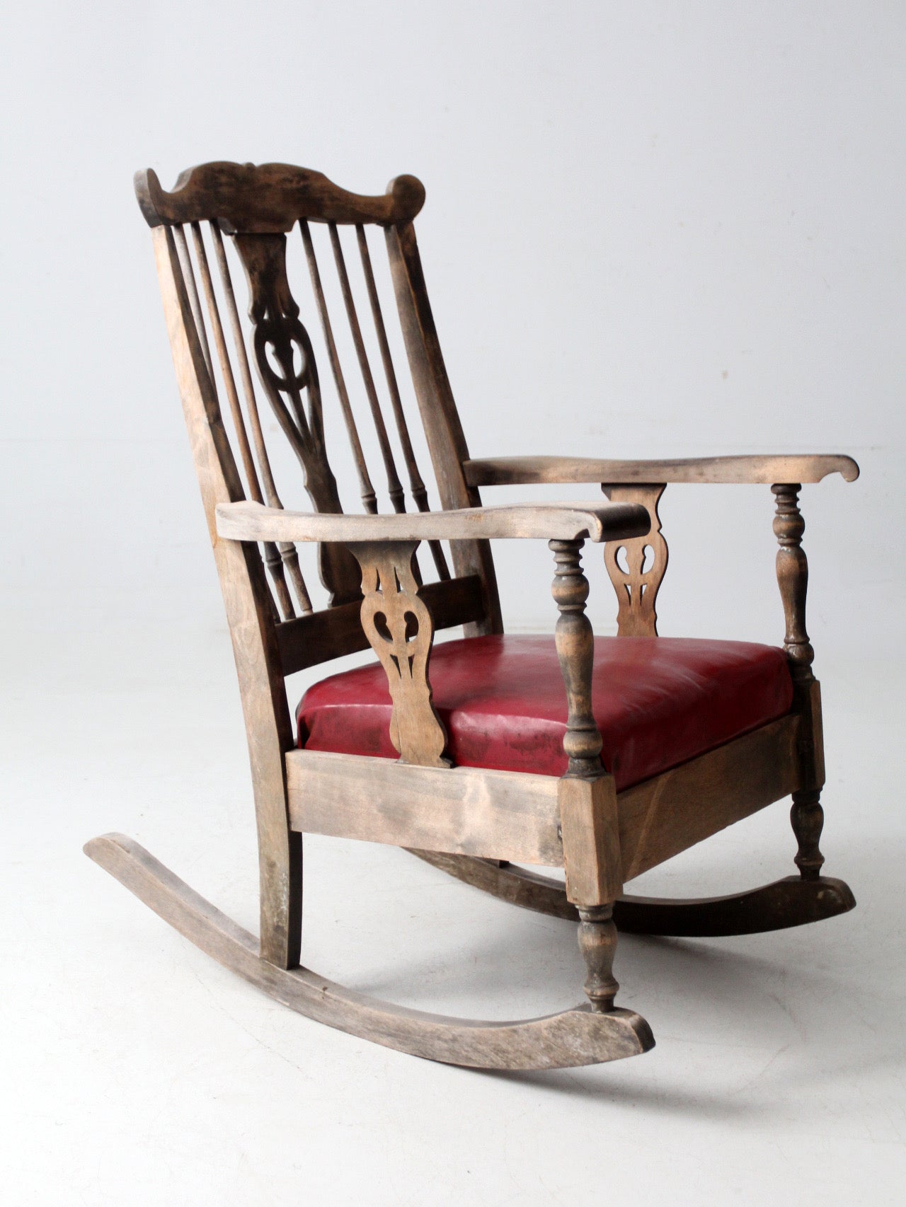 antique wooden rocking chair with upholstered seat