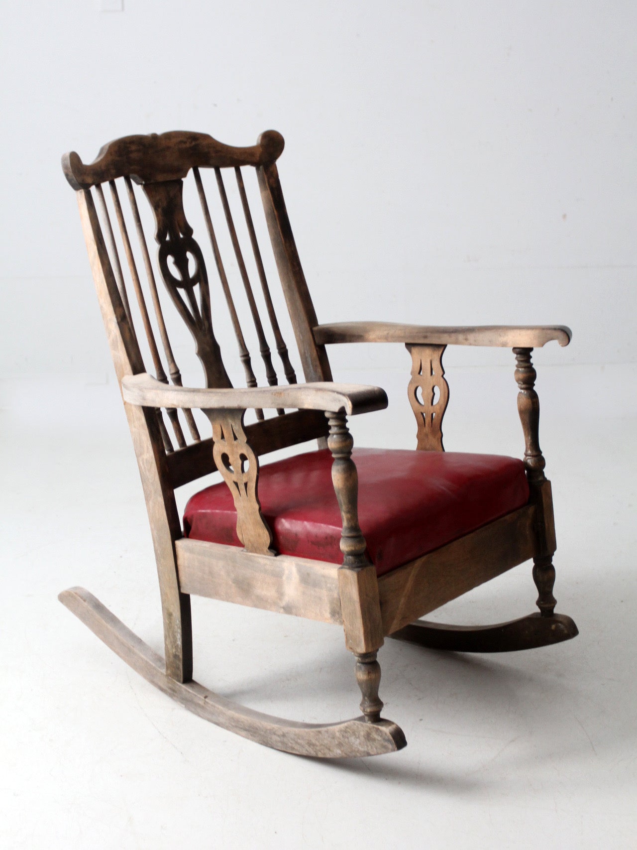 antique wooden rocking chair with upholstered seat
