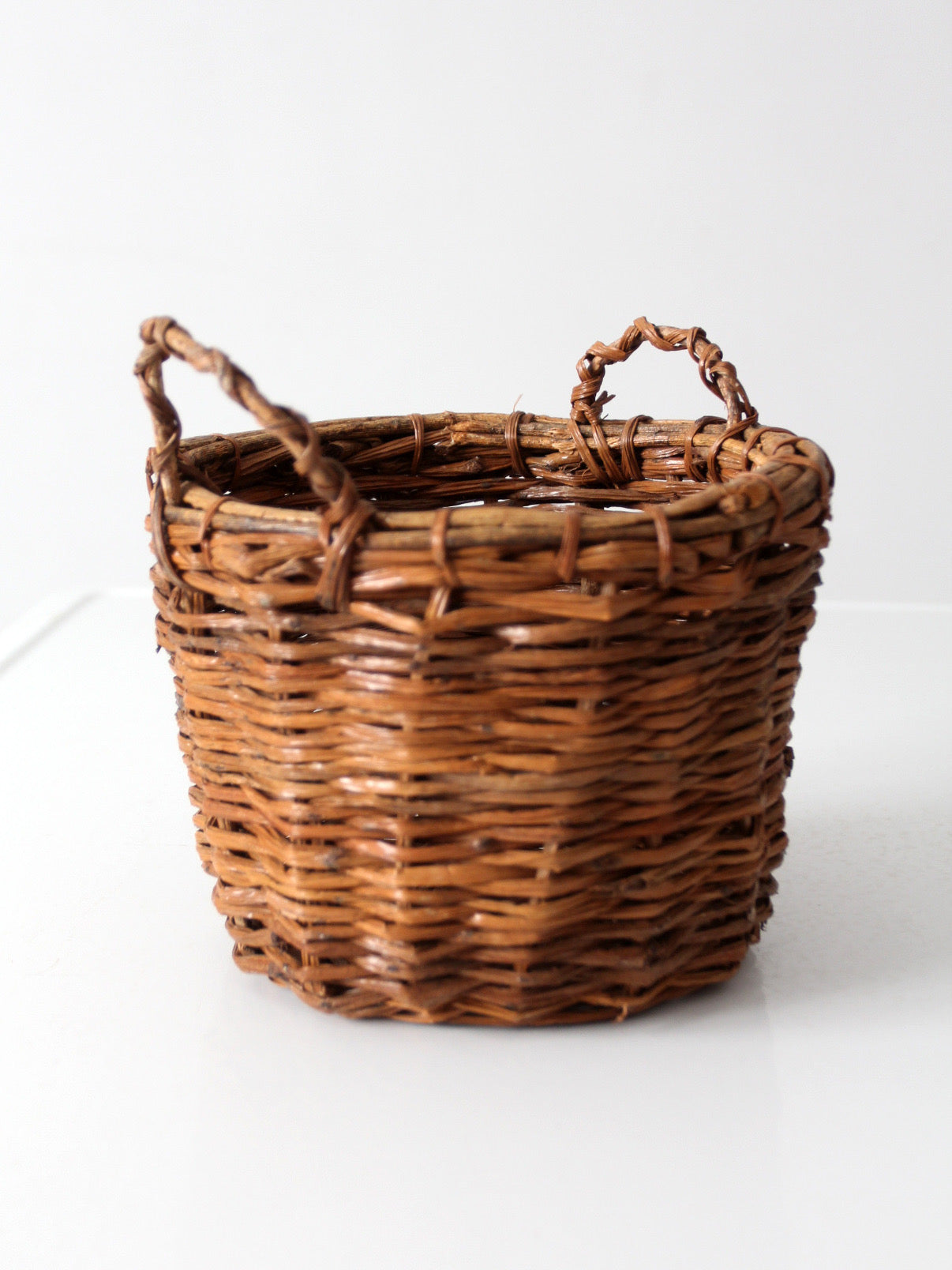 vintage handmade wicker basket with twisted handles