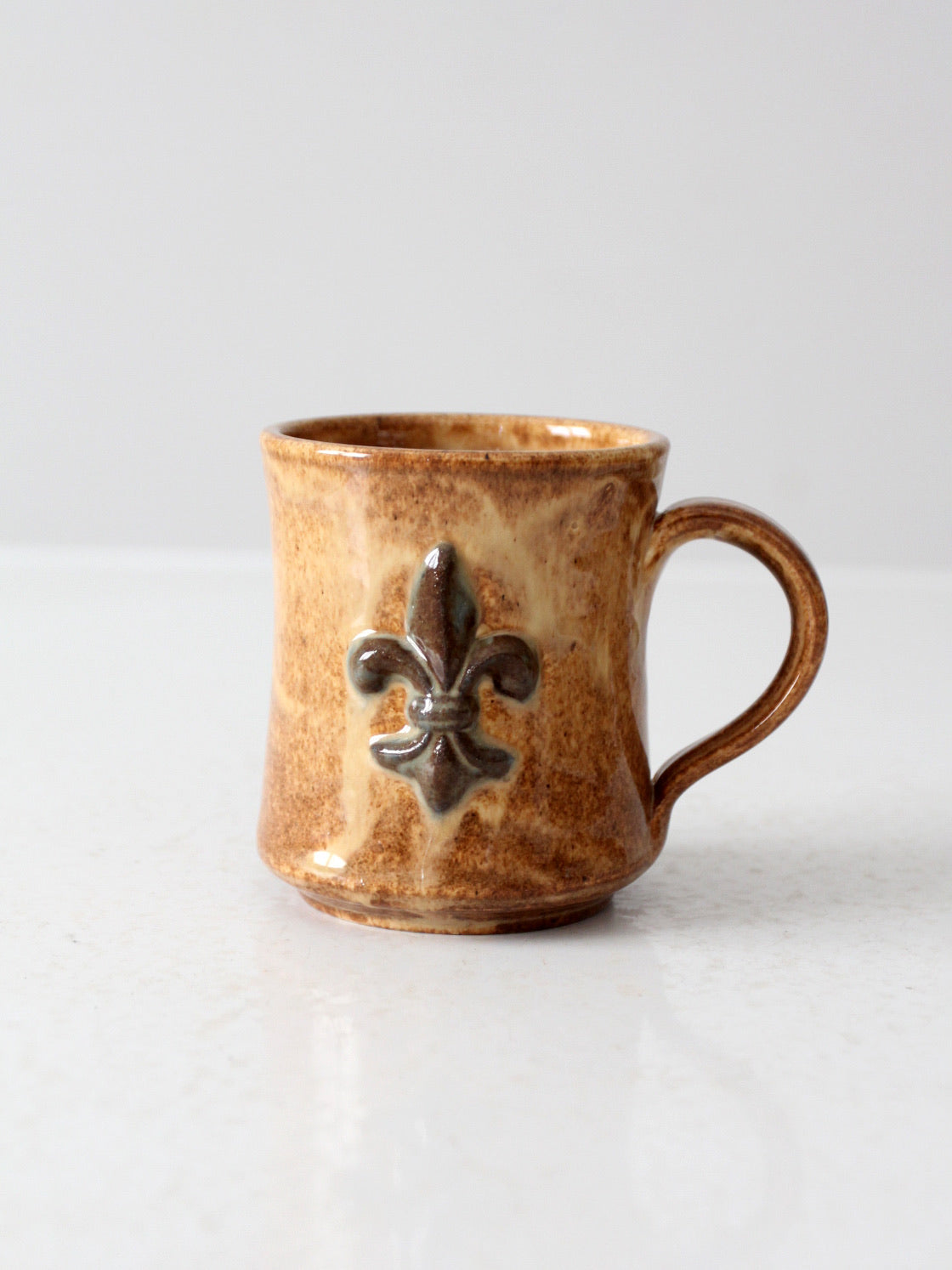 vintage studio pottery mug with fleur-di-lis