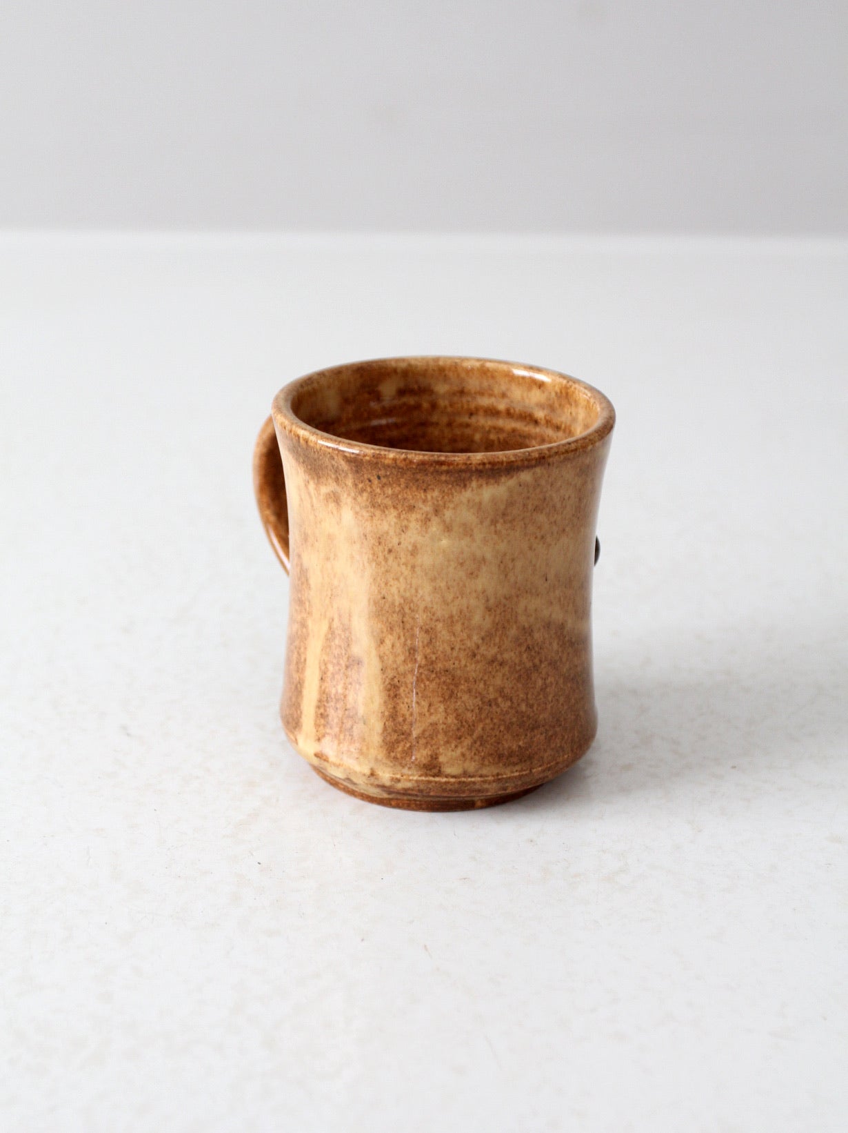 vintage studio pottery mug with fleur-di-lis