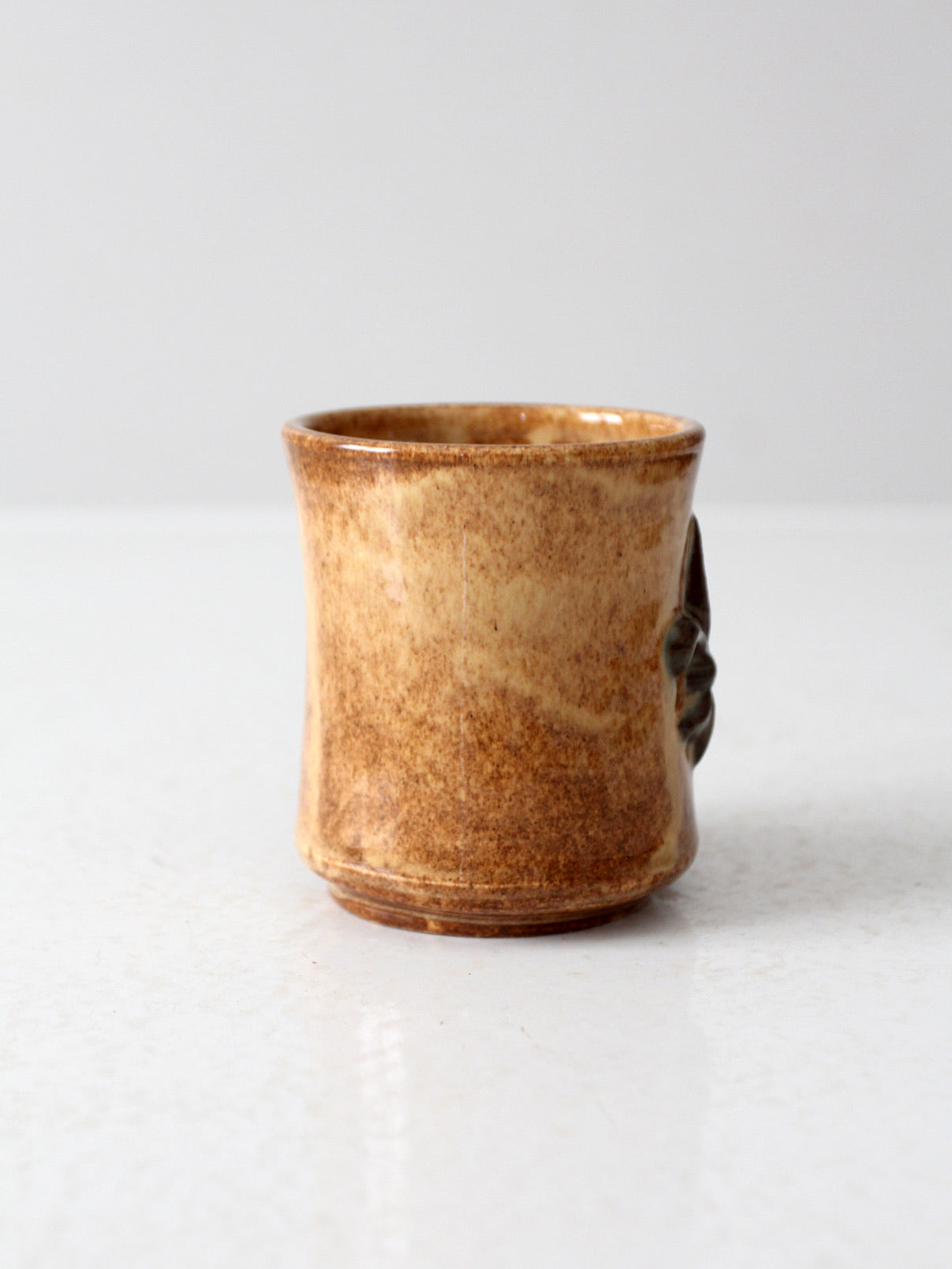 vintage studio pottery mug with fleur-di-lis