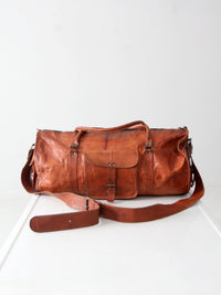 vintage brown leather duffle bag with shoulder strap