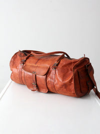 vintage brown leather duffle bag with shoulder strap