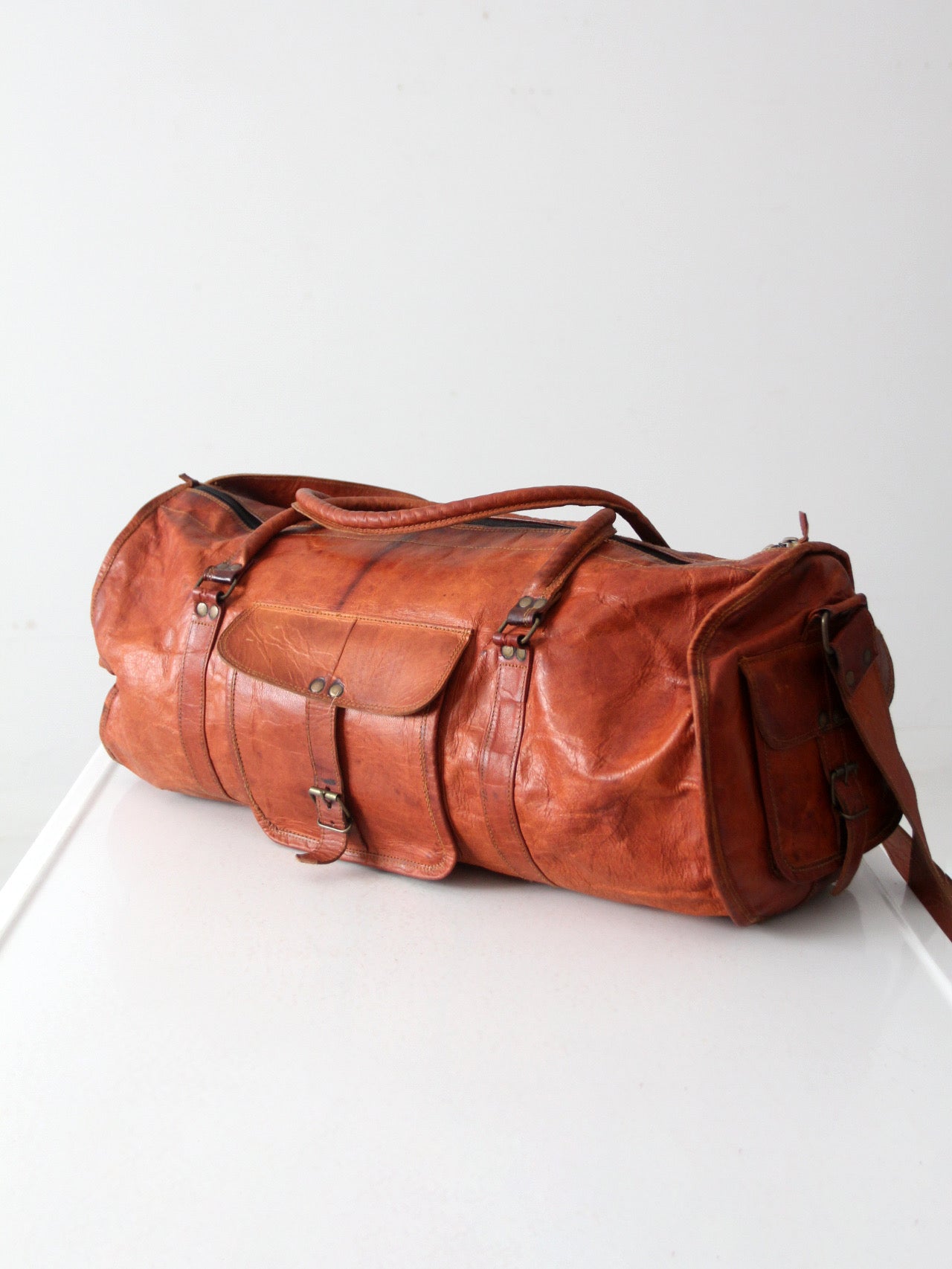 vintage brown leather duffle bag with shoulder strap