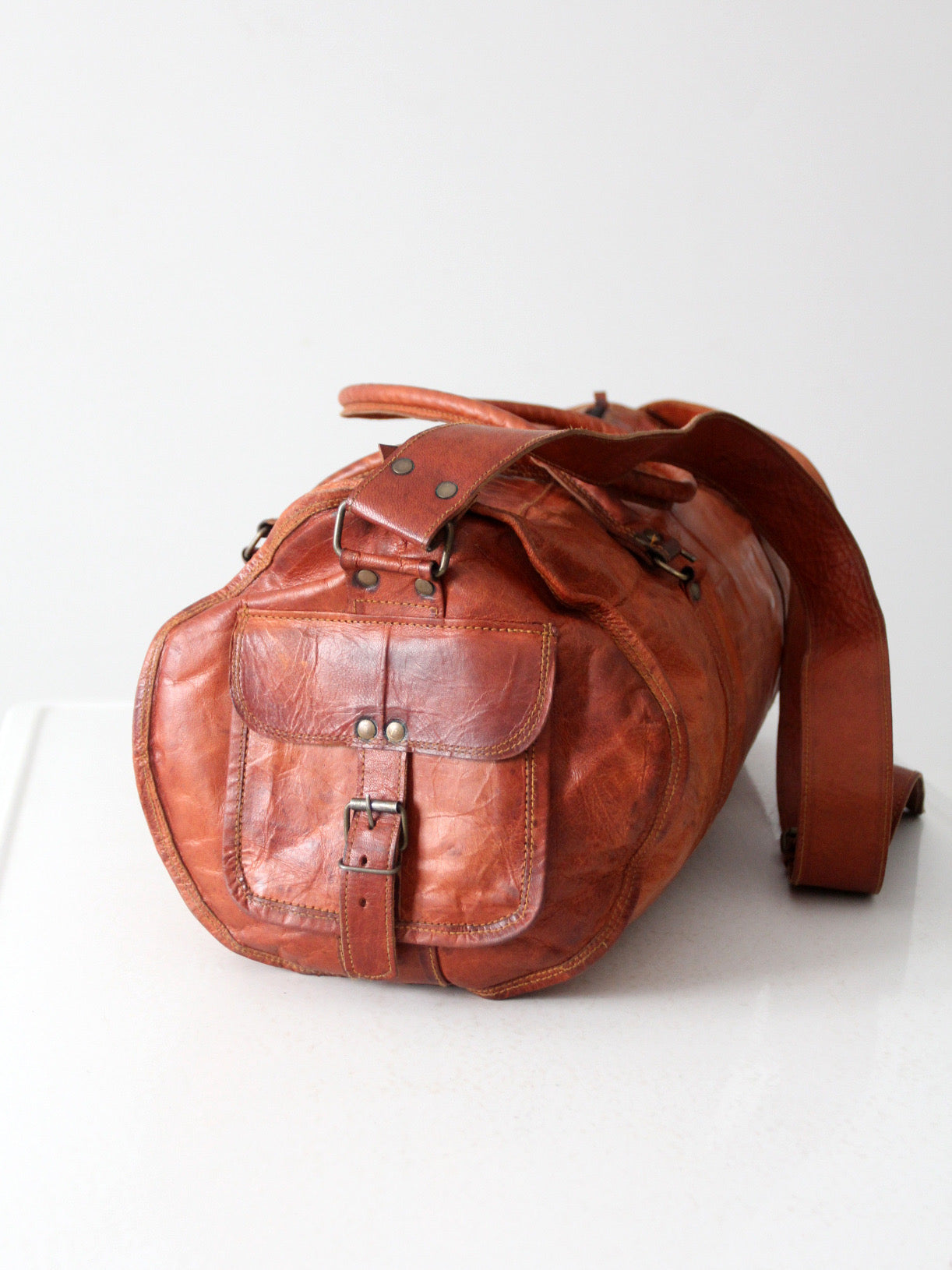 vintage brown leather duffle bag with shoulder strap